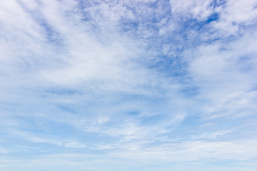 Transparent blue sky with clouds and atmospheric afternoon.