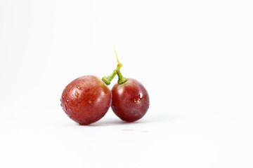 Red grapes on white background.