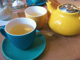 Breakfast in the cafe. Teapot, Cup and saucer. Bright, colorful colors. Close-up photo.
