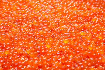 A lot of red caviar. Selective focus.