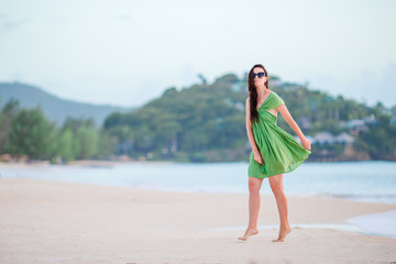 Fototapeta na wymiar Young beautiful woman having fun on tropical seashore.