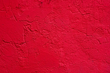Background of a red stucco coated and painted exterior, rough cast of cement and concrete wall texture, decorative coating