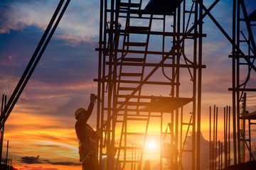 Silhouette of construction worker during sunset