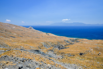kos island secluded beach near thermal springs, with some peddles magical blue water of the aegean sea in greece