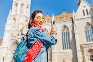 Asian hipster girl making photos on the smartphone in Budapest, Hungary