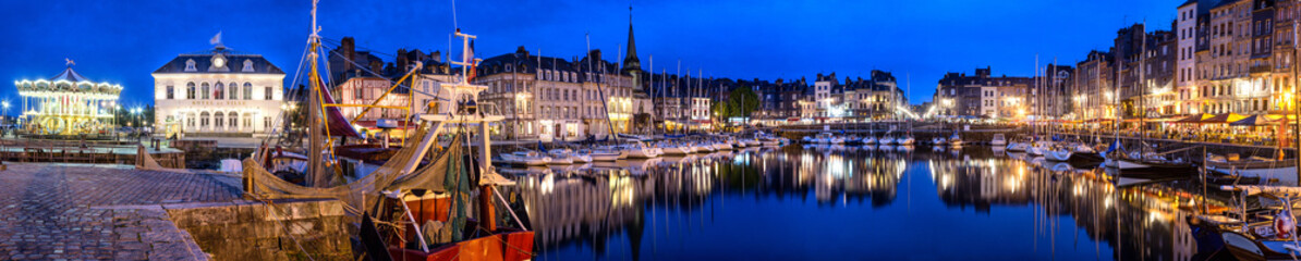 Panoramic view at dusk of the beautiful Honfleur harbour, which offers many fine restaurants overlooking the water - obrazy, fototapety, plakaty