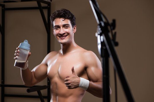 Man with nutrient supplements in sports gym