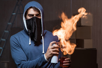 Rebel with molotov cocktail in dark room