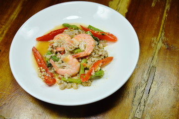 spicy stir fried minced pork and shrimp with basil leaf on plate