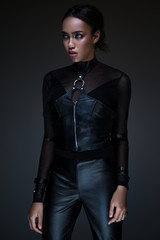 Half body view of black woman with gothic outfit posing on dark background