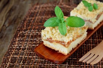 Pieces of grated pie with caramel