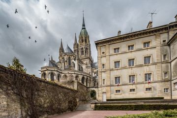 Fototapeta premium Bayeux's 13th century Gothic cathedral stands behind the deportation memorial in Normandy