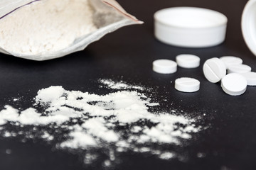 Drugs on black background. Narcotic drugs addicted.