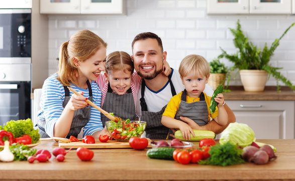 appy family with child  preparing vegetable salad