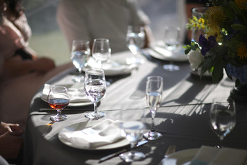 Guests at a served table with glasses of cognac and cold water in a restaurant