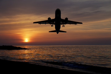 Fototapeta na wymiar sunset sea and airplane
