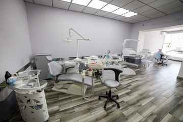 Modern dentistry office interior with chair and tools - medicine, medical equipment and stomatology concept