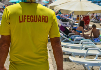 Rescuer on the beach bypasses vacationers