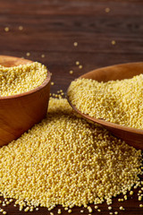 Lentils in a wooden bowl on rustic wooden background, top view, close-up, selective focus.