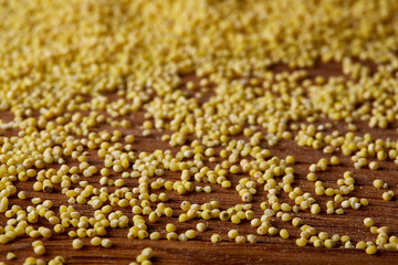 Lentils in a wooden bowl on rustic wooden background, top view, close-up, selective focus.
