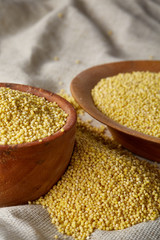 Lentils in a wooden bowl on rustic wooden background, top view, close-up, selective focus.