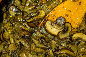 fried with onions and spices Royal mushrooms champignons in a frying pan