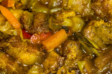 Roast meat, onions, carrots and spices, boiling in oil