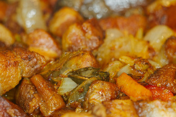 Roast meat, onions, carrots and spices, boiling in oil