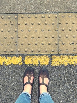 Standing Behind The Yellow Line With Sandals