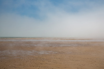 Mist rolls into the beach at Omaha beach in Normandy, France