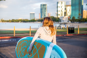 Sunrise in Waikiki a yoga teacher getting ready to teach SUP Yoga