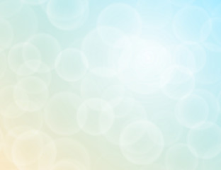 Vector bokeh texture on a bright two-tone blue-yellow background. Festive abstract blur background.