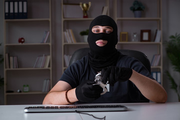 Hacker hacking computer late at night