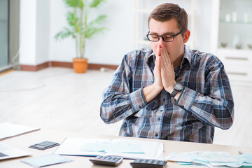Young man frustrated at his house and tax bills