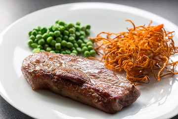 Beef steak with green peas and sweet potato