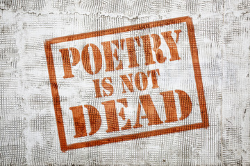 poetry is not dead -  graffiti on stucco wall