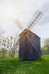 Old windmill in the forest. The sun's rays. Spring. Nature.