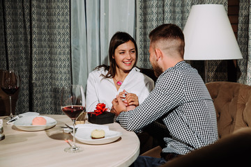 Closeup image of a happy young woman at a date with her boyfriend on the foreground