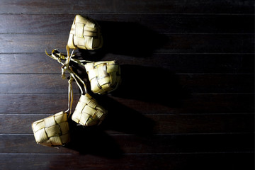 Ketupat rice dumpling, a Malaysia traditional food for Hari Raya celebration in a rustic wooden...