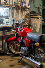Red vintage motorcycle parked in the garage