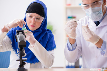 Two chemists working in the lab