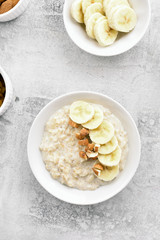 Oatmeal porridge with banana slices and nuts