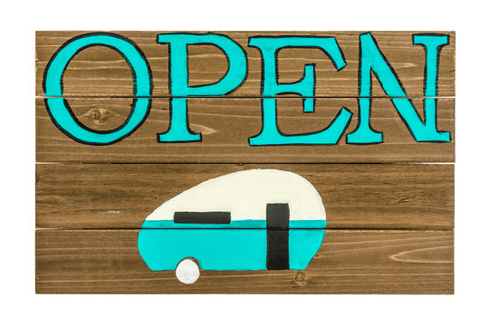 Campground open sign painted on wooden panel