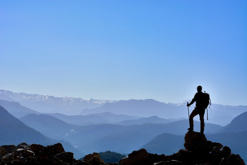 successful people at the height of desolate and fascinating mountains