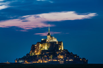Mont St Michel Abbey illuminated at dusk in Normandy