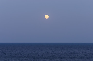 Sea landscape with a full moon