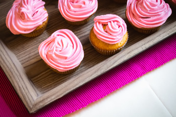 small muffins cupcakes with whipped cream pink