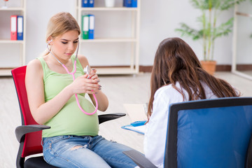Pregnant woman visiting doctor for regular check-up