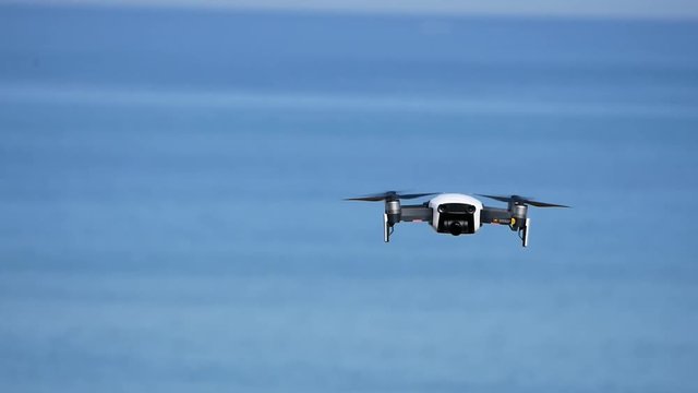 a flight of drone with a camera over the sea