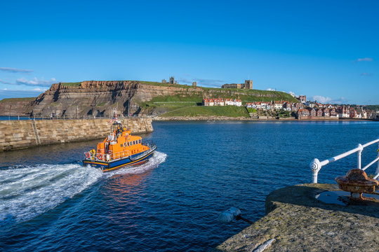 Lifeboat returning into Whitby below the Abbey